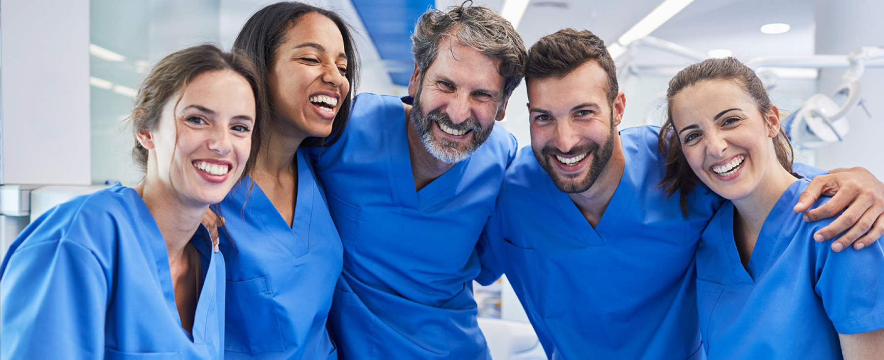 Smiling nurses huddled together